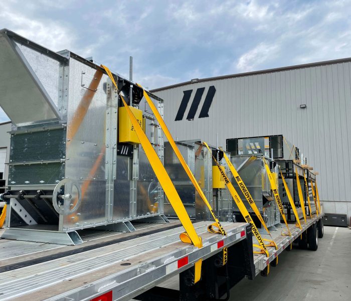 Bucket elevator parts loaded and strapped onto a flatbed truck